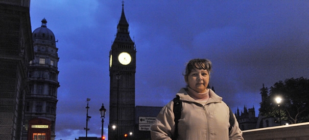 Recipeint of Dispossessed Fund grant standing next to Big Ben nighttime silhouette